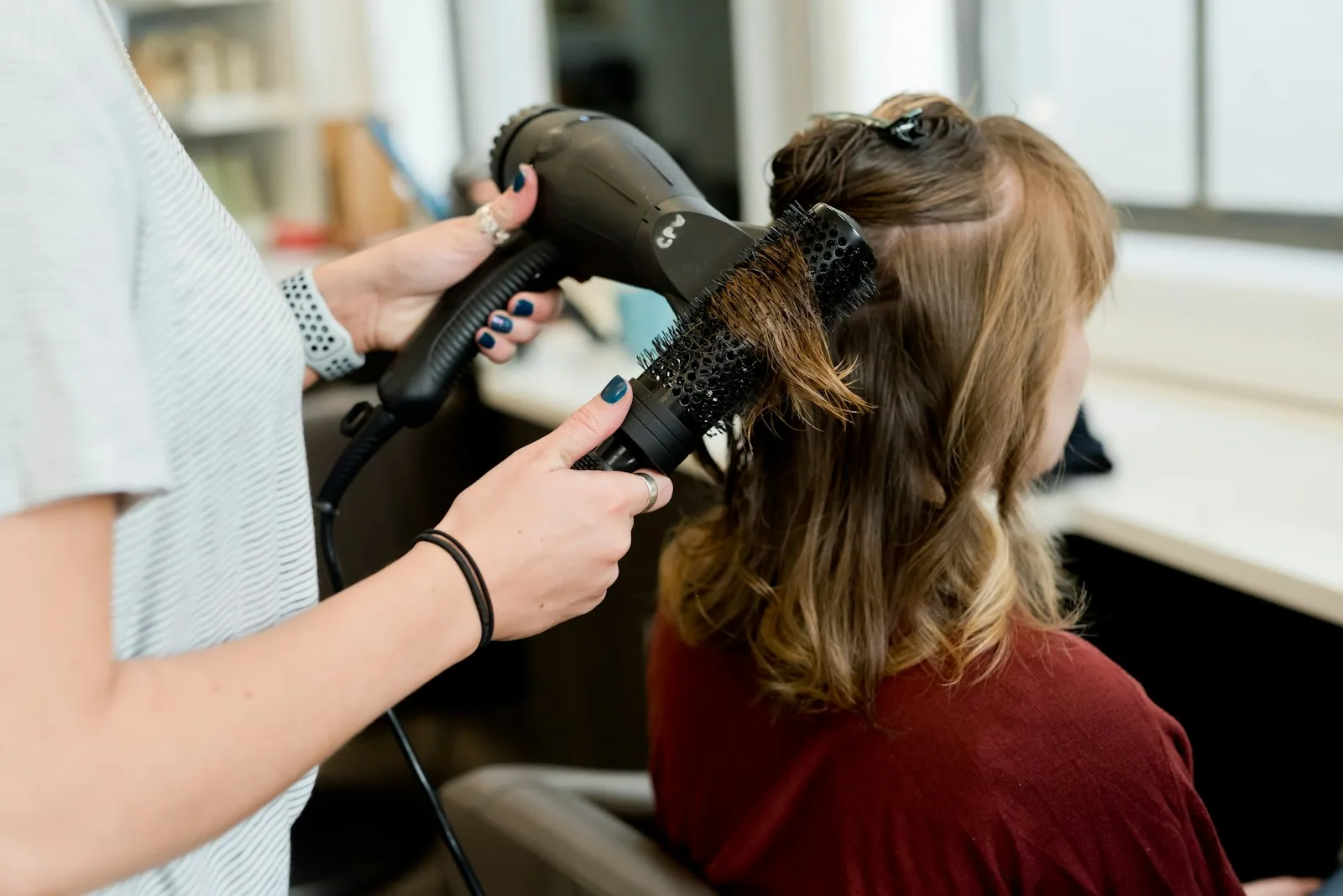 Stylist shaping a client’s hair