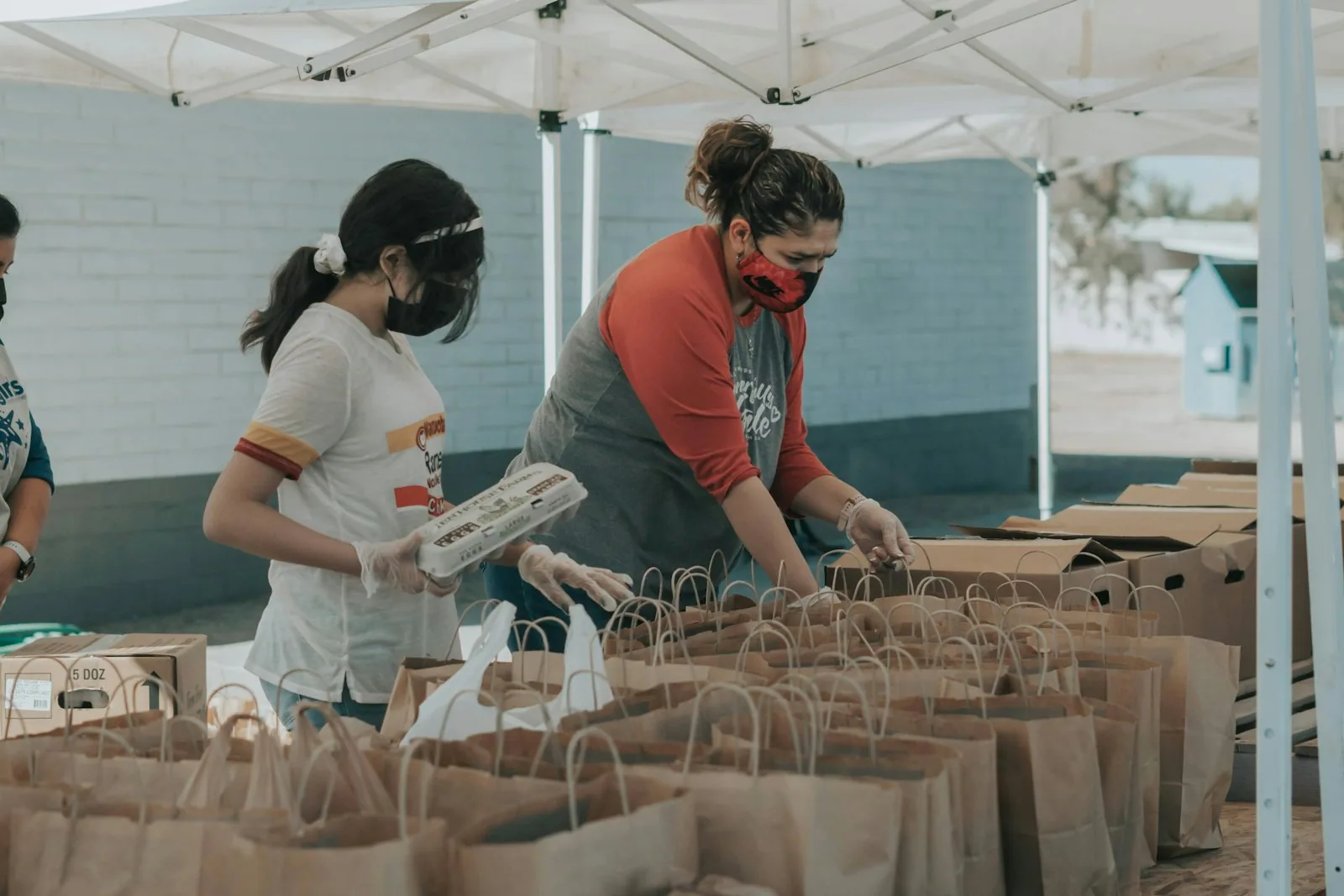 Community volunteers preparing paper bags